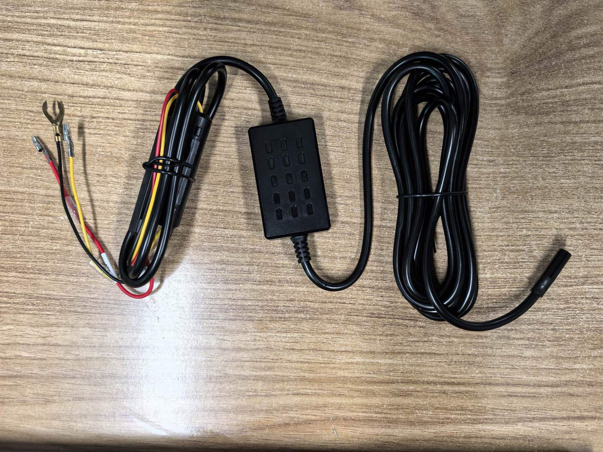 Car dashcam hardwiring harness with connectors on a wooden surface