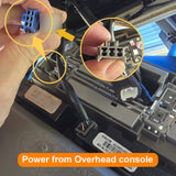Close-up of a car interior with wiring and connectors, highlighting power from overhead console.