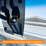Close-up of a car's lane keep assist system with text overlay.