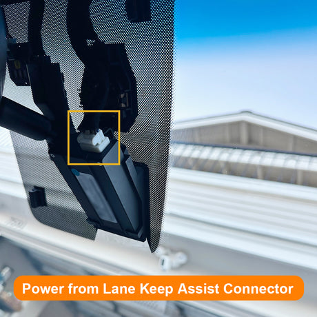 Close-up of a car's lane keep assist system with text overlay.